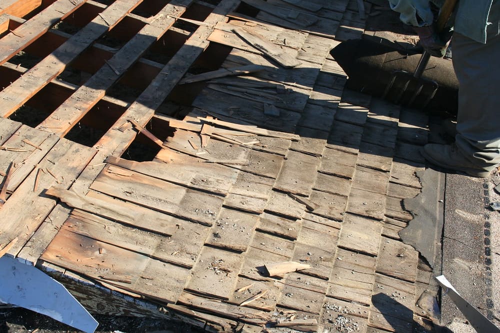 Roofing crew working on an exposed roof section